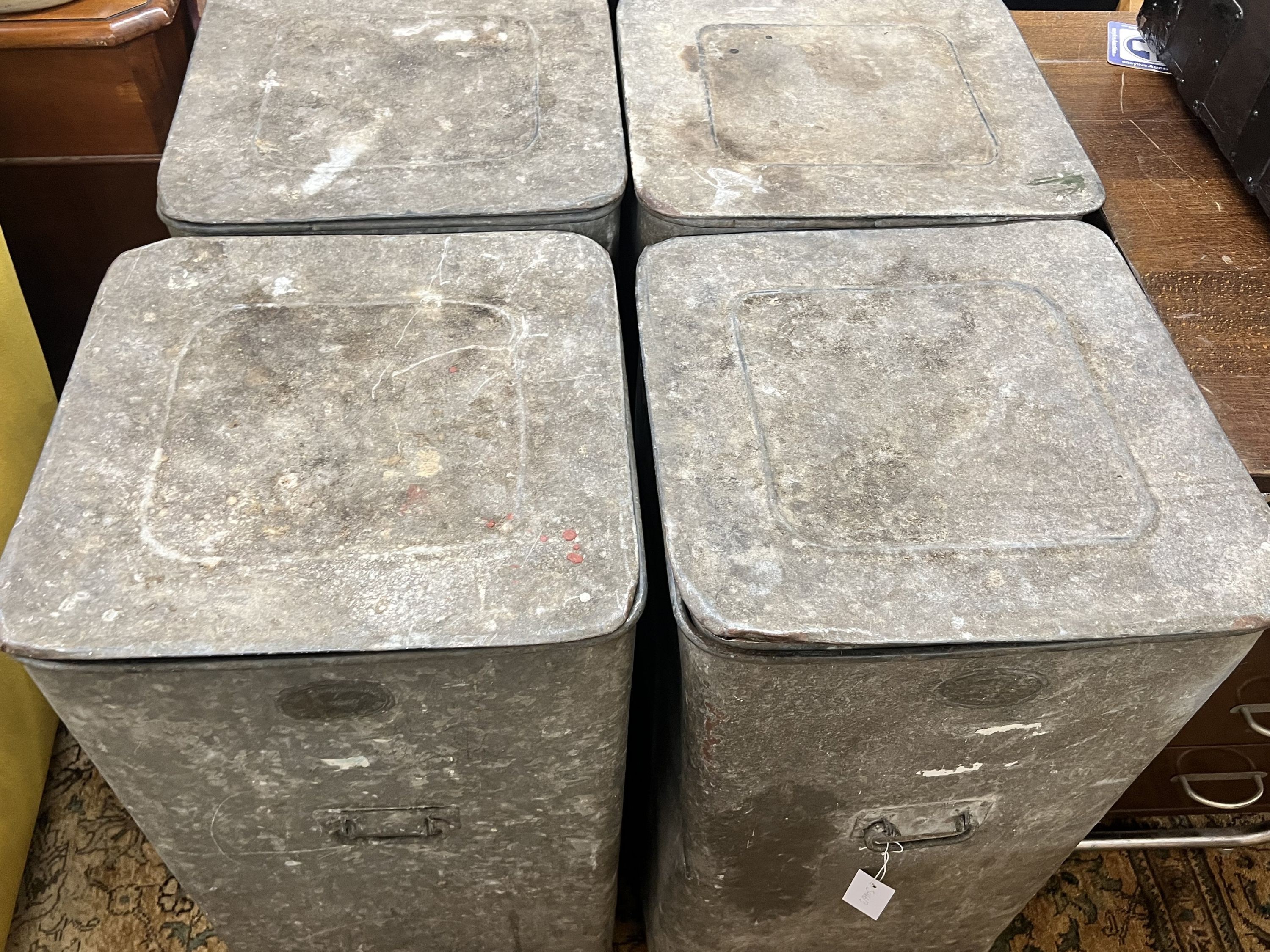 A set of four Youngs Patent galvanised grain bins with covers, width 42cm depth 42cm height 77cm